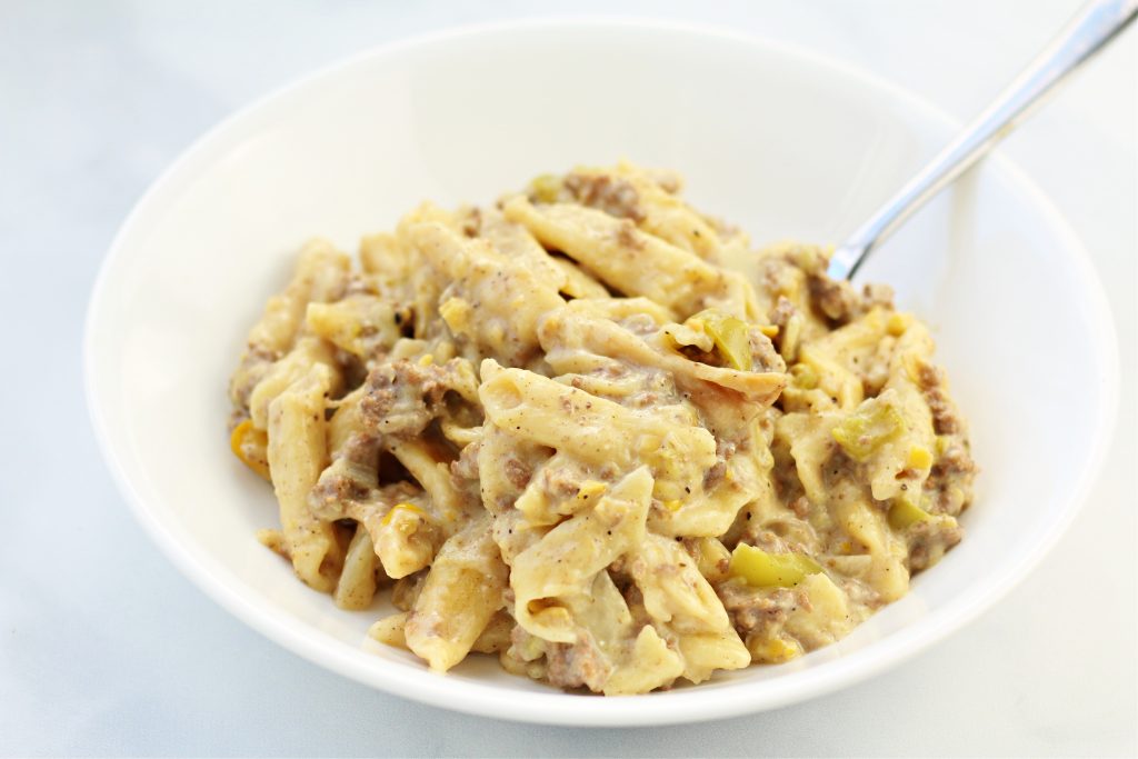 hamburger and penne pasta in a white bowl
