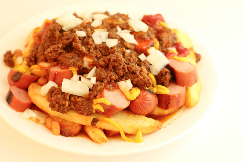 Instant Pot Garbage Plate--a homemade version of the Garbage Plate that you'll find in Rochester, NY. This is extreme American cuisine at its finest! Cook the delicious meat sauce in your Instant Pot or slow cooker. 