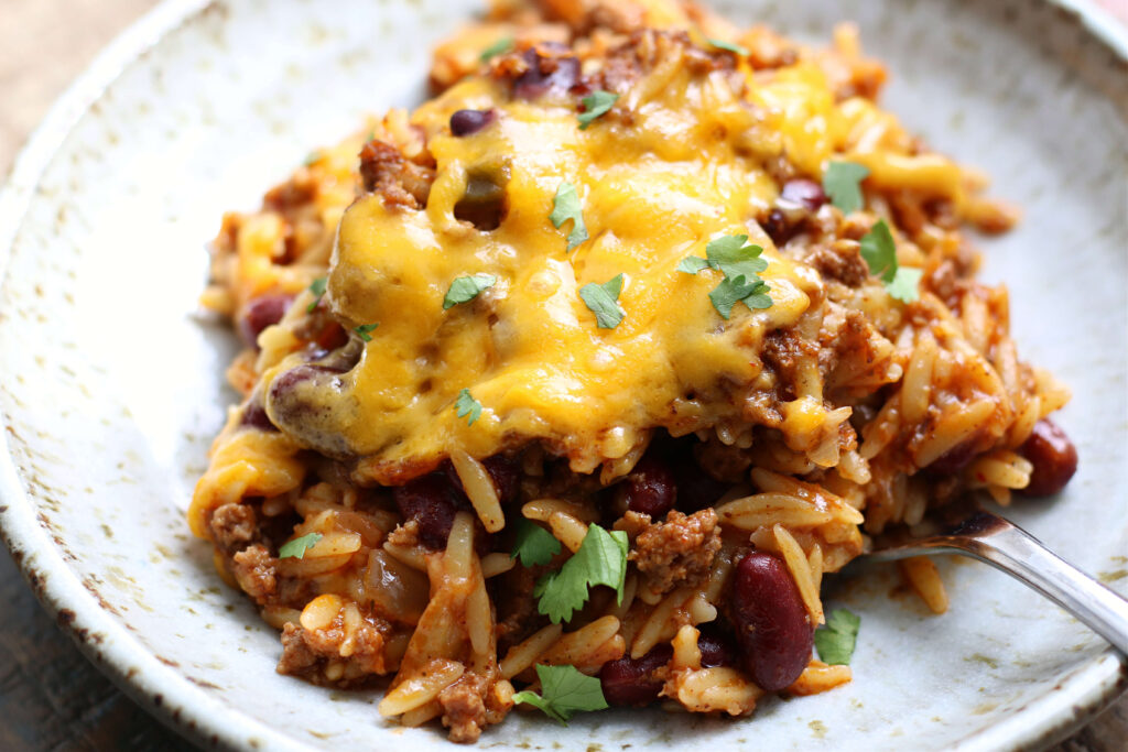 Pasta with your choice of ground meat, chili beans, salsa and cheese. An easy recipe that can be made into a freezer meal. Mix and match what you have on hand to make an inexpensive dinner tonight!