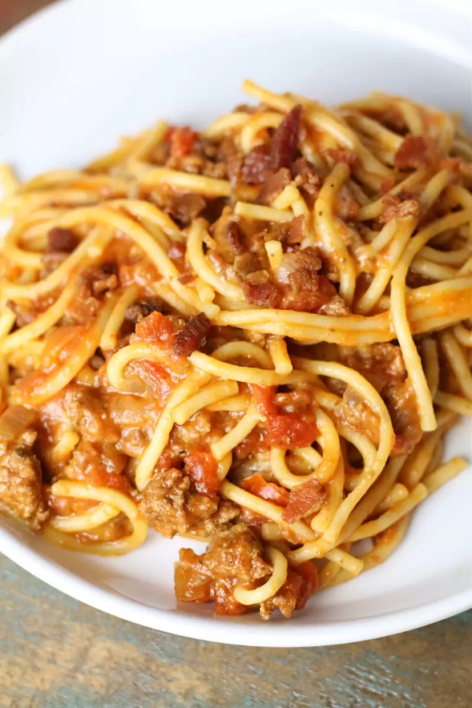 Instant Pot Cowboy Spaghetti–an easy spaghetti recipe with bacon, ground beef, Rotel, barbecue sauce and cheese. A hearty pasta dish that comes together quickly with the help of your Instant Pot.