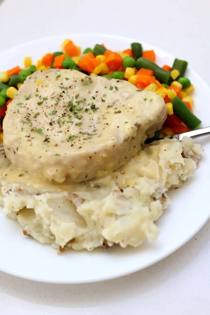 Instant Pot Ranch Pork Chops and Mashed Potatoes—creamy mashed potatoes are served with ranch seasoned pork chops and gravy. All made in one pot at the same time!