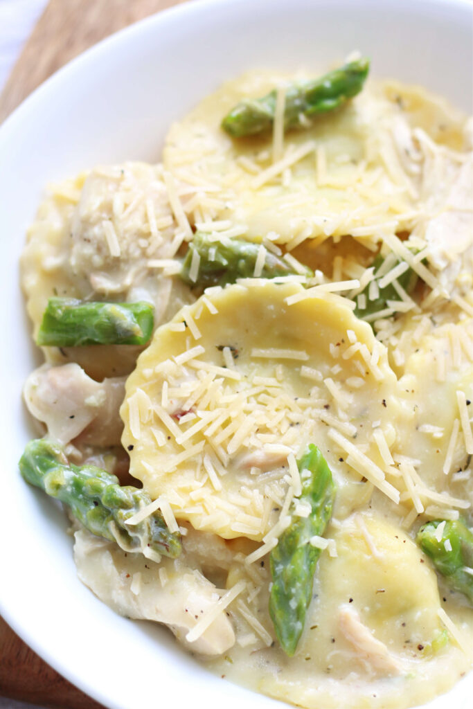 spinach and cheese filled ravioli with lemon cream sauce and chicken and asparagus