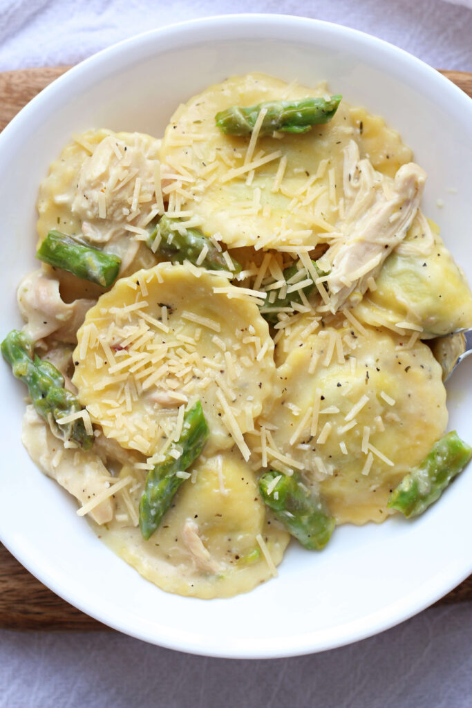 spinach and cheese filled ravioli with lemon cream sauce and chicken and asparagus