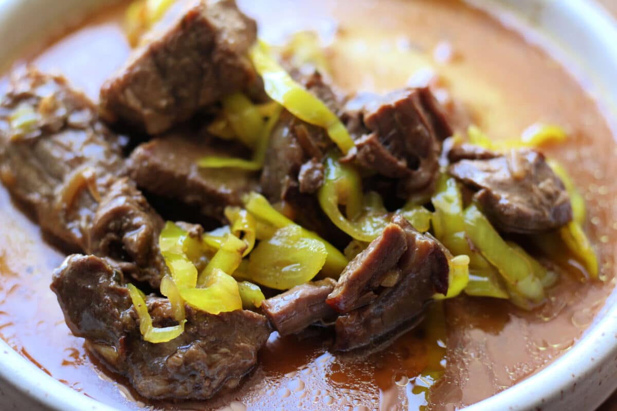 Crockpot Mississippi Steak Bites are made with tender beef stew meat, ranch seasoning, au jus, butter, and pepperoncinis for an easy slow cooker or Instant Pot dinner that's packed with bold flavor.