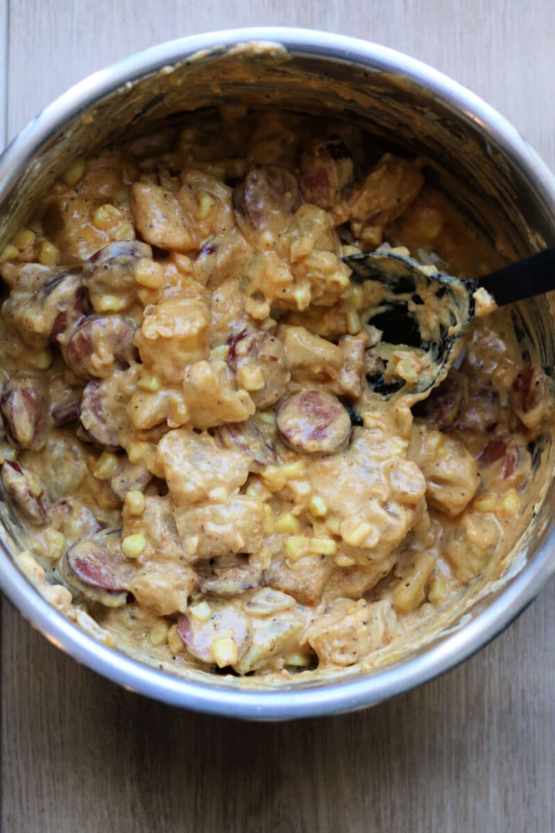 Kielbasa Sausage Cheesy Potato Casserole--an Instant Pot or slow cooker dinner made with smoked sausage, tender potatoes, sweet corn, cheddar cheese, and a creamy sauce.