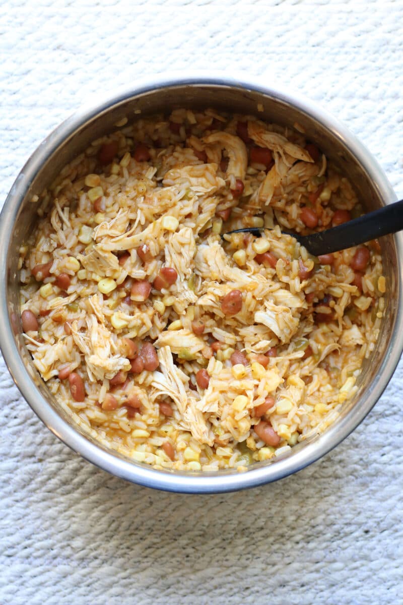 Western Cowgirl Casserole--an Instant Pot dinner made with tender chicken, ranch seasoning, rice, ranch style beans, green chiles, and corn for an easy one pot meal.