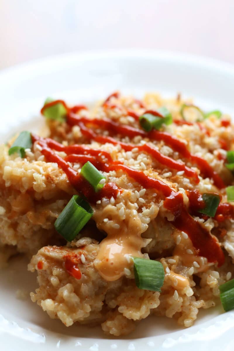 Bang Bang Cheesy Chicken Casserole--an easy Instant Pot dinner made with tender chicken, jasmine rice, melted mozzarella cheese and a creamy homemade bang bang sauce topped with crispy panko, green onions and sesame seeds.