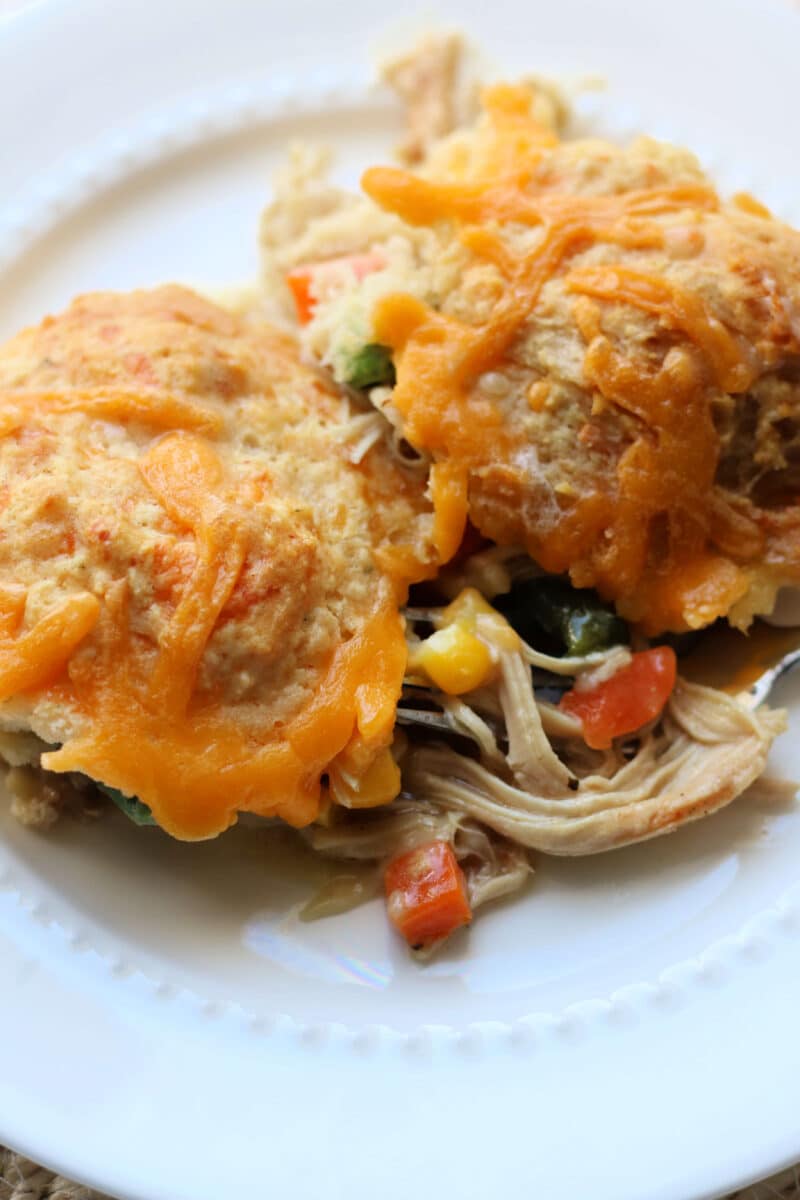 Easy Cheesy Chicken Cobbler Casserole--seasoned shredded chicken, frozen vegetables, Cheddar Bay Biscuit Mix, and a creamy chicken gravy for a comforting one-pan dinner.