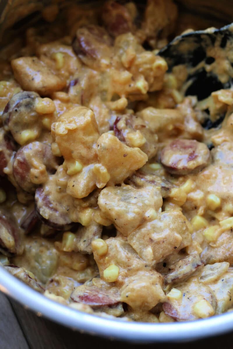 Kielbasa Sausage Cheesy Potato Casserole--an Instant Pot or slow cooker dinner made with smoked sausage, tender potatoes, sweet corn, cheddar cheese, and a creamy sauce.