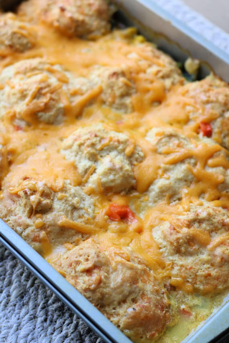 Easy Cheesy Chicken Cobbler Casserole--seasoned shredded chicken, frozen vegetables, Cheddar Bay Biscuit Mix, and a creamy chicken gravy for a comforting one-pan dinner.