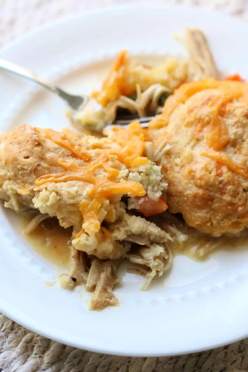 Easy Cheesy Chicken Cobbler Casserole--seasoned shredded chicken, frozen vegetables, Cheddar Bay Biscuit Mix, and a creamy chicken gravy for a comforting one-pan dinner.