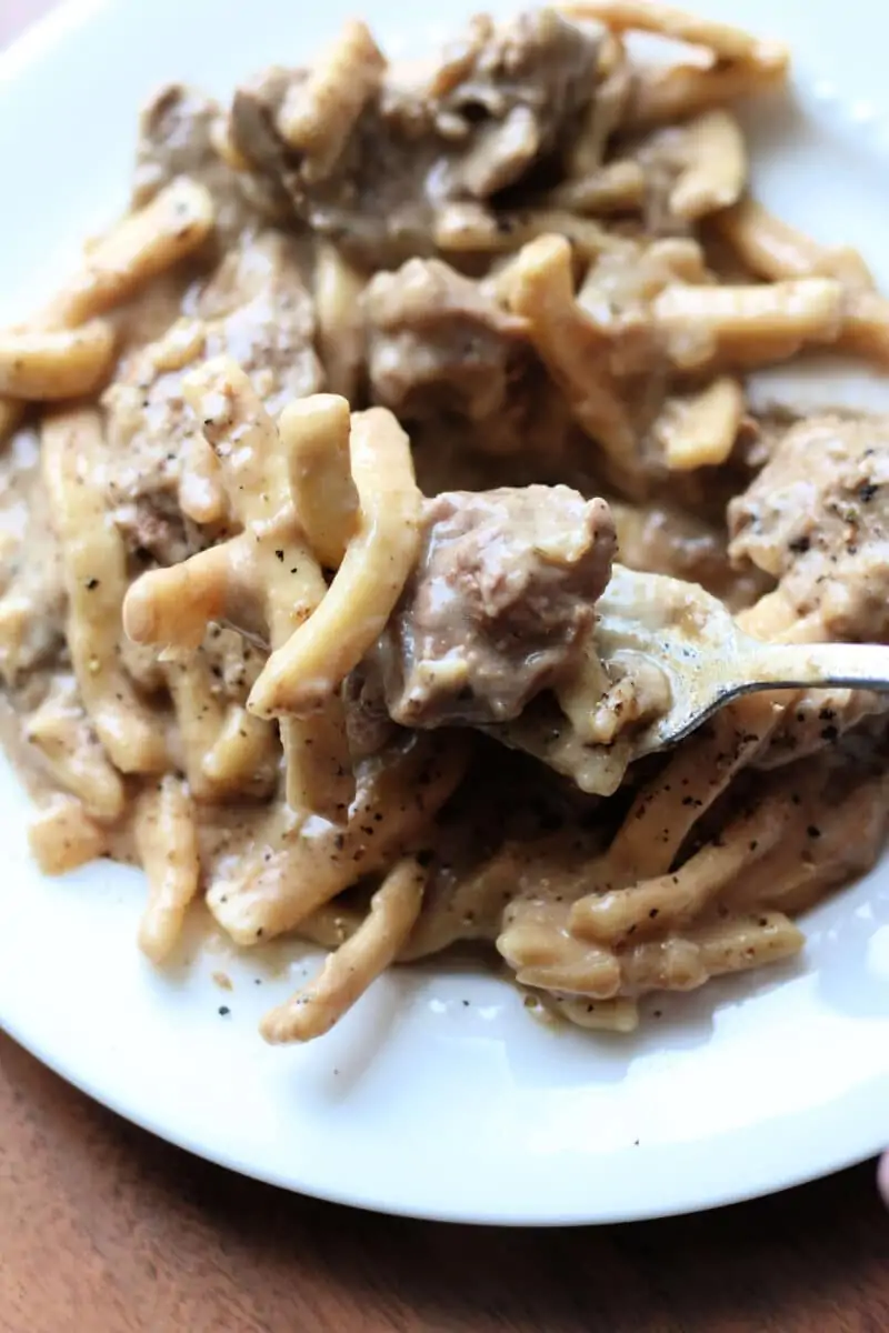 Crockpot French Onion Beef and Noodles--tender beef, sweet caramelized onions, frozen egg noodles, and a creamy French onion-inspired sauce in the slow cooker or Instant Pot.
