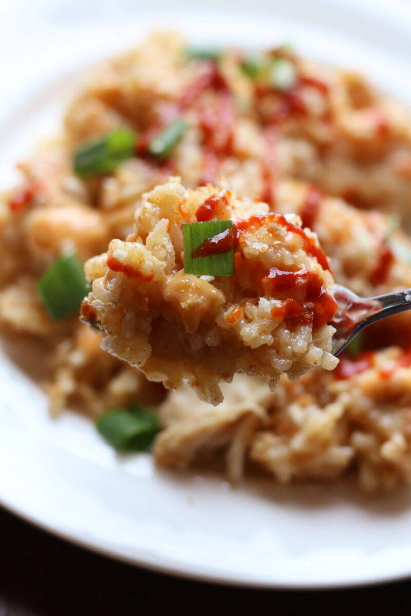 Bang Bang Cheesy Chicken Casserole--an easy Instant Pot dinner made with tender chicken, jasmine rice, melted mozzarella cheese and a creamy homemade bang bang sauce topped with crispy panko, green onions and sesame seeds.