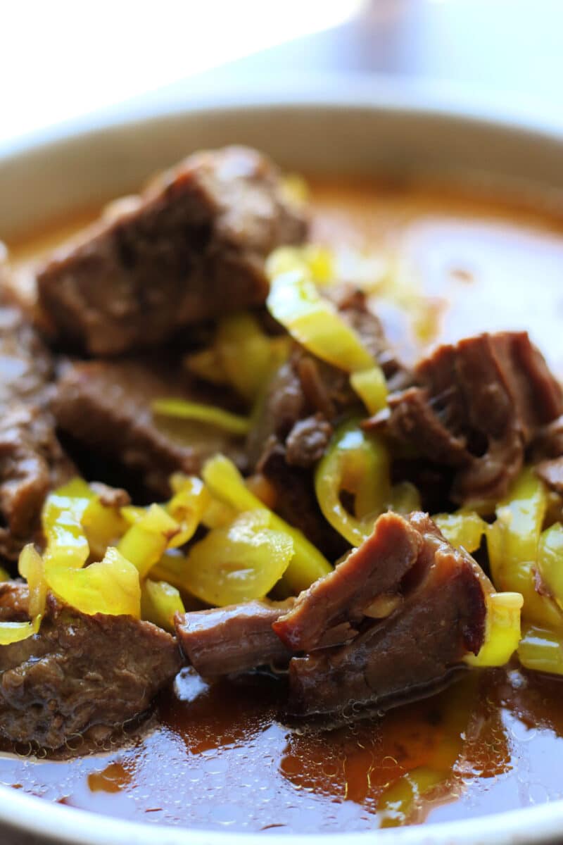 Crockpot Mississippi Steak Bites are made with tender beef stew meat, ranch seasoning, au jus, butter, and pepperoncinis for an easy slow cooker or Instant Pot dinner that's packed with bold flavor.