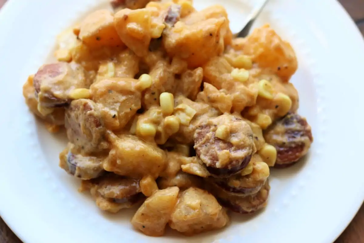 Kielbasa Sausage Cheesy Potato Casserole--an Instant Pot or slow cooker dinner made with smoked sausage, tender potatoes, sweet corn, cheddar cheese, and a creamy sauce.