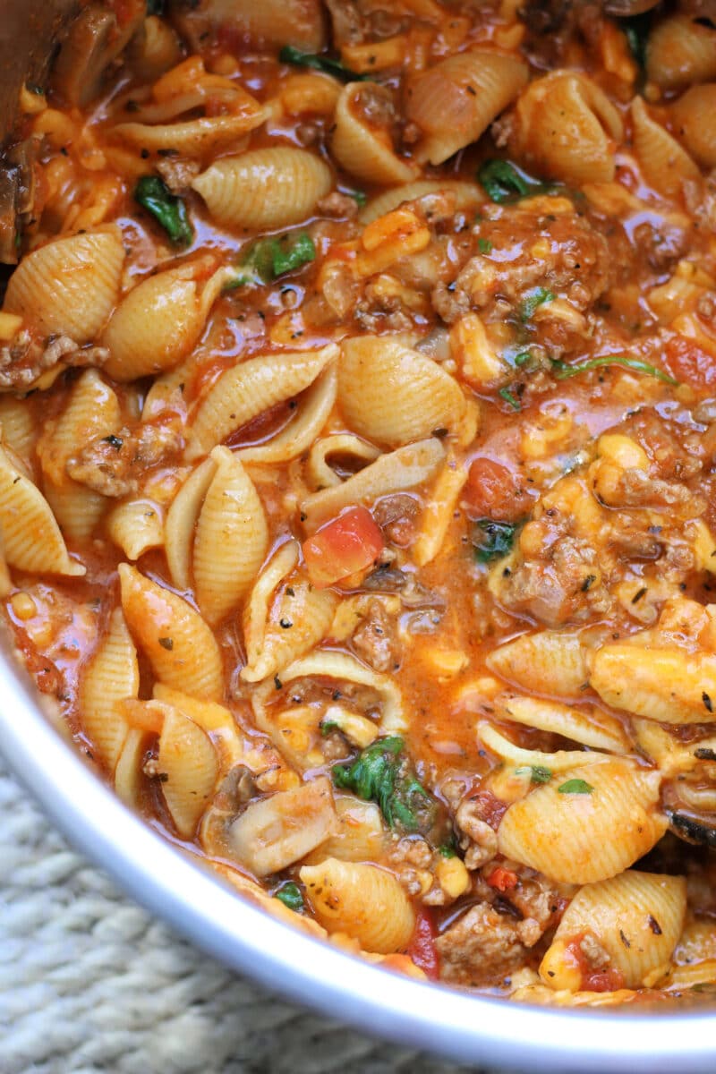 Amish Frolic Casserole--an easy Instant Pot pasta dinner made with ground beef, medium pasta shells, tomato basil sauce, fresh spinach, mushrooms and melty cheddar cheese.