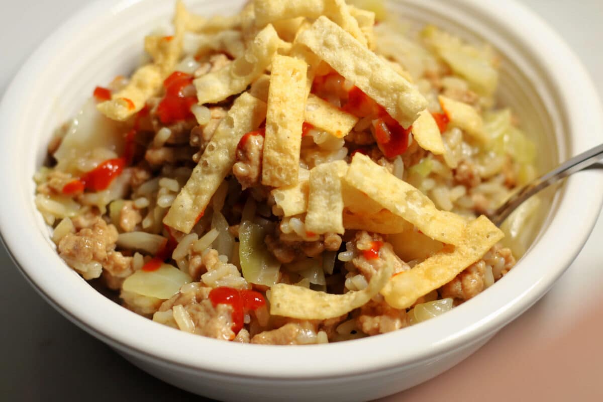 Chicken Egg Roll Casserole--an easy one-pot dinner made with ground chicken, cabbage, rice, ginger and garlic, then topped with crunchy wonton strips. Make it fast in the Instant Pot.