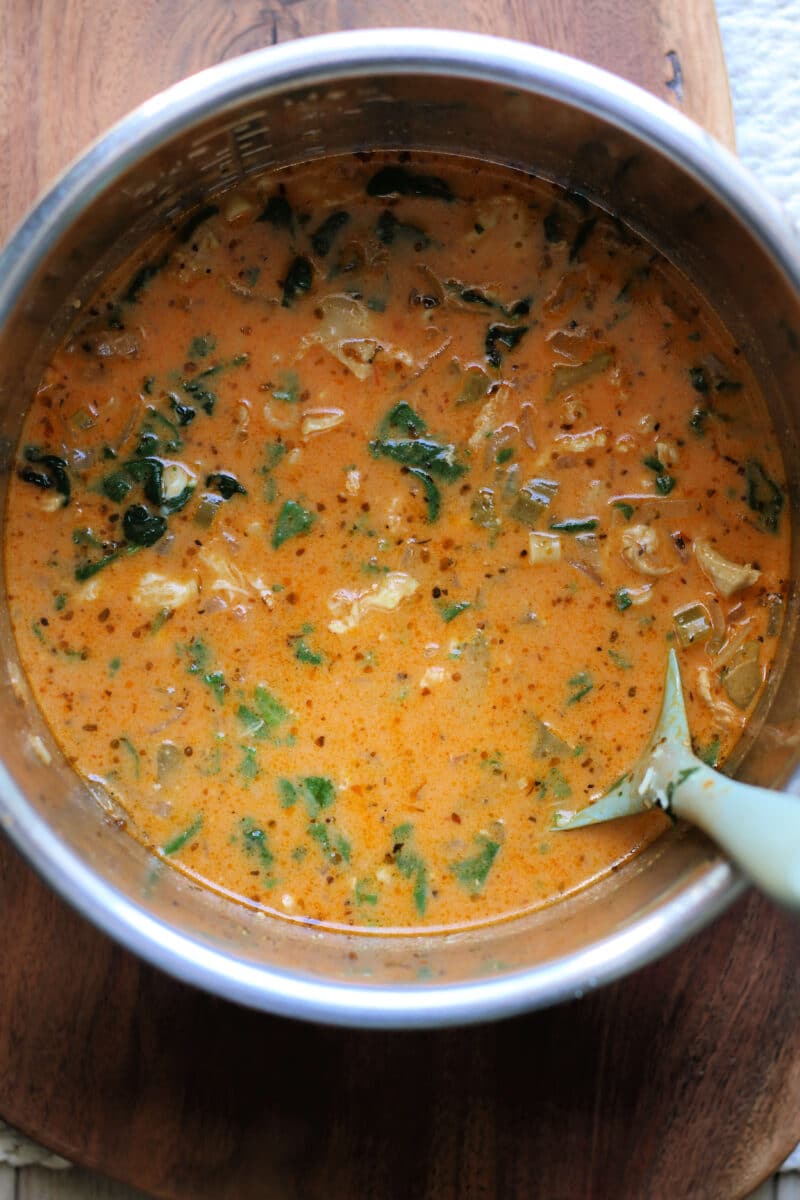 Creamy Tuscan Garlic Parmesan Chicken Soup--an easy Instant Pot or slow cooker soup made with tender chicken, ditalini pasta, spinach, tomato sauce, and sun-dried tomato pesto.