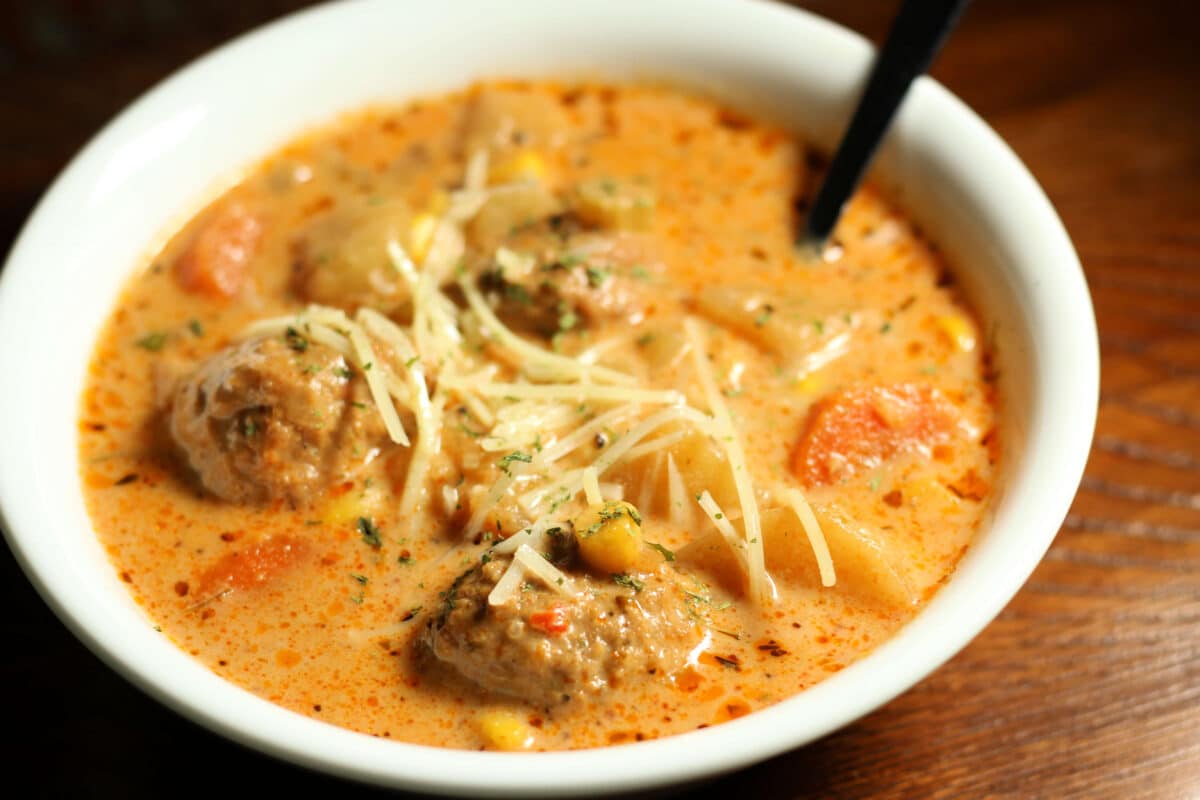 Crockpot Cheesy Italian Meatball Soup--an easy dump and go slow cooker soup made with tender meatballs, potatoes, vegetables and Parmesan cheese in a creamy, savory broth.