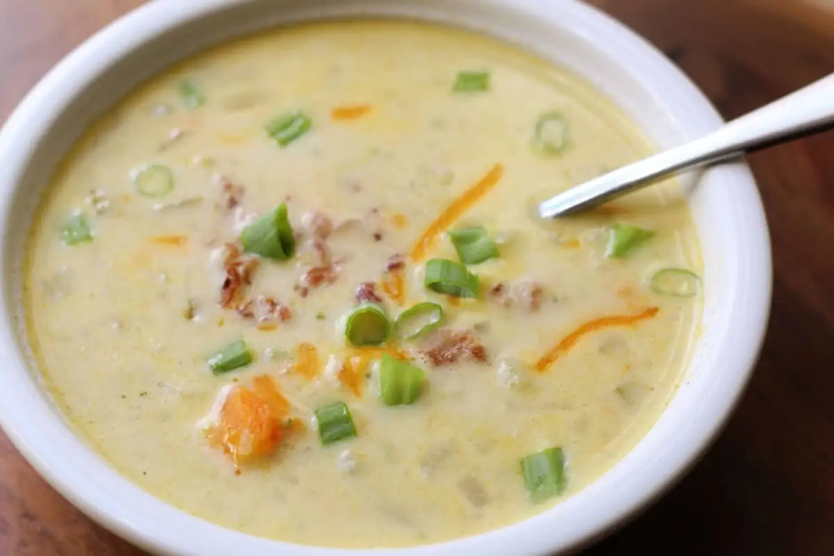Crockpot Potato Broccoli Cheddar Soup--a dump and go creamy slow cooker (or Instant Pot) vegetable soup loaded with potatoes, broccoli, cauliflower, carrots and sharp cheddar cheese for an easy dinner.