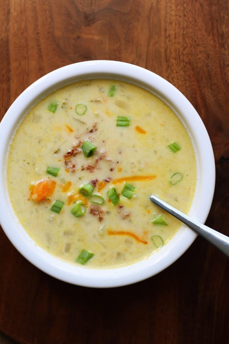 Crockpot Potato Broccoli Cheddar Soup--a dump and go creamy slow cooker (or Instant Pot) vegetable soup loaded with potatoes, broccoli, cauliflower, carrots and sharp cheddar cheese for an easy dinner.