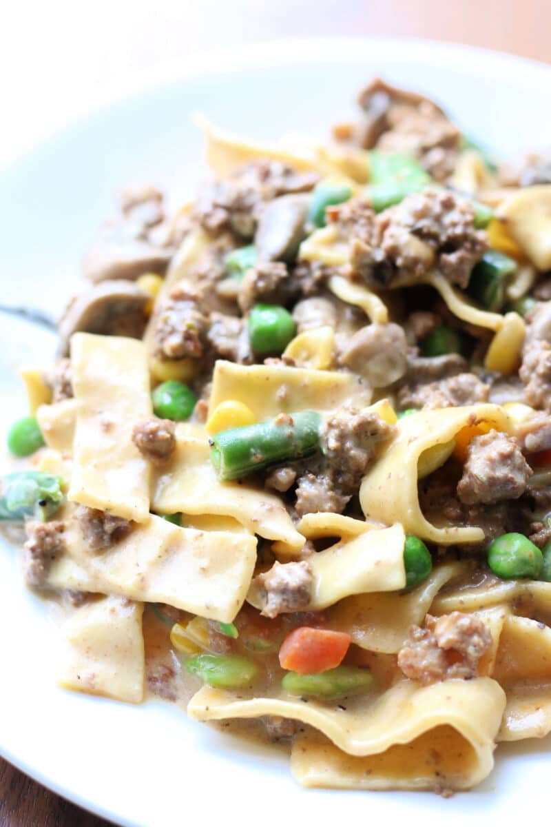 Dolly Parton's Creamy Beef Noodle Casserole--an easy one-pot dinner made with seasoned ground beef, tender egg noodles, vegetables, mushrooms, sour cream and cheddar cheese.