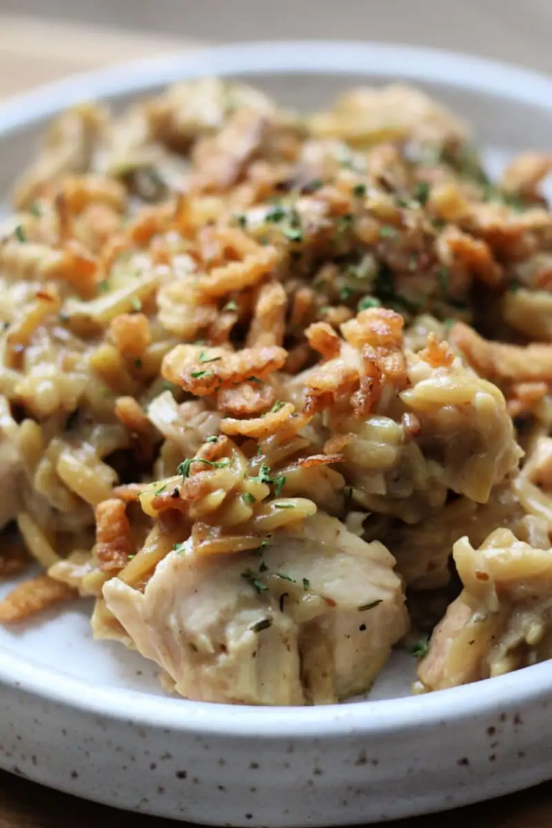French Onion Chicken Orzo Casserole--an easy Instant Pot dinner with tender chicken and creamy orzo with savory caramelized onions, Parmesan cheese and crispy French fried onions.