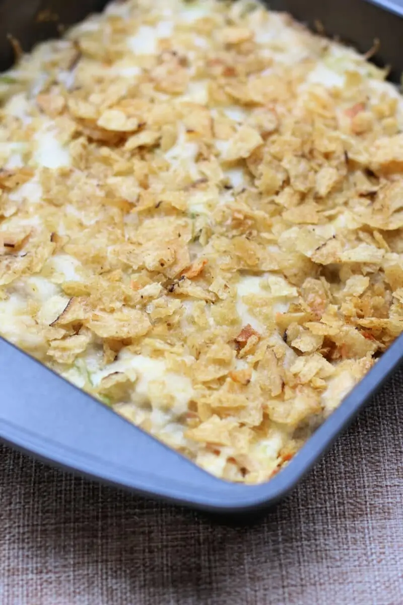 Joy's Memory Making Chicken Casserole--comfort food chicken casserole with tender shredded chicken, creamy sauce, dill pickle flavor, melty Monterey Jack cheese and a buttery potato chip topping.