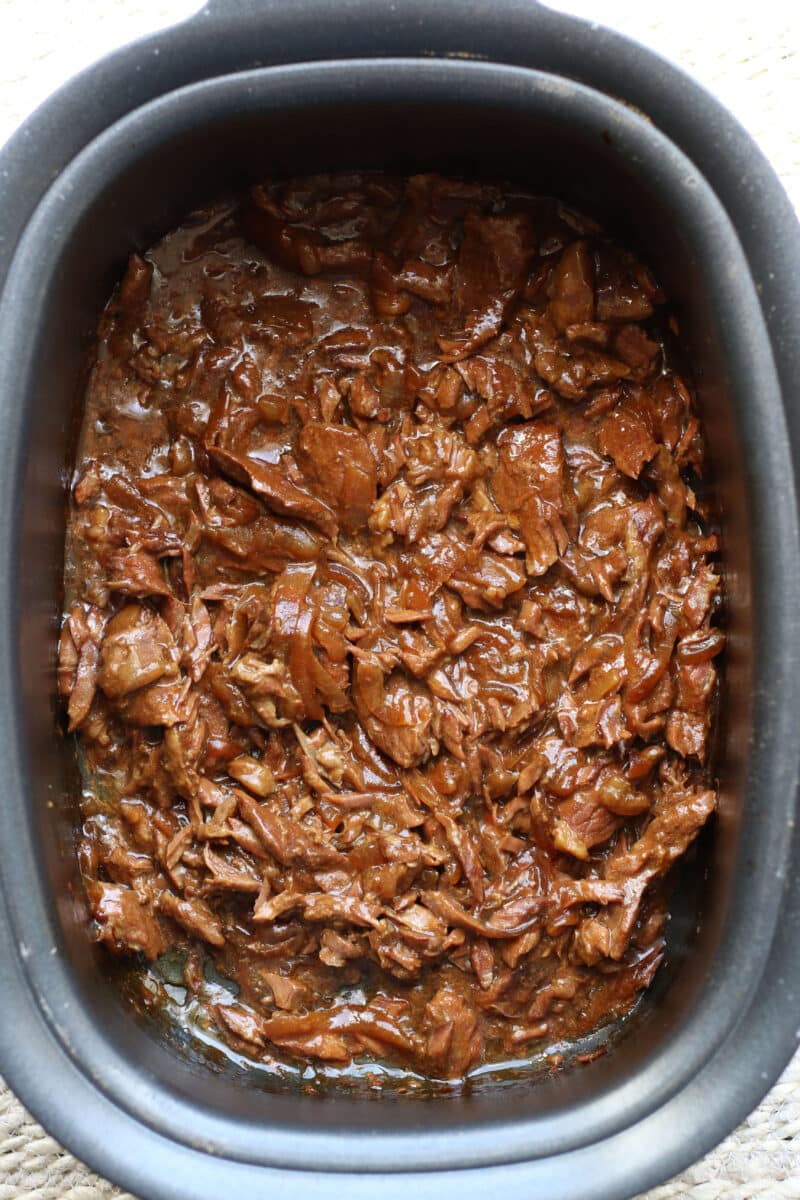 Slow Cooker Round Steak and Gravy--tender beef, onions, garlic and au jus gravy for a simple dump-and-go dinner that’s perfect served over mashed potatoes or egg noodles.