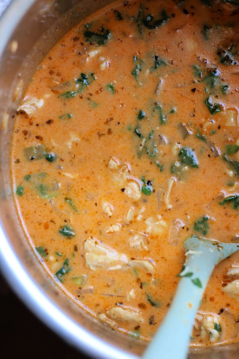 Creamy Tuscan Garlic Parmesan Chicken Soup--an easy Instant Pot or slow cooker soup made with tender chicken, ditalini pasta, spinach, tomato sauce, and sun-dried tomato pesto.
