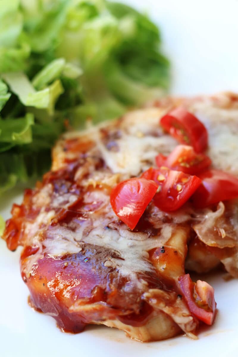 4-Ingredient Monterey Chicken Bake--an easy oven-baked chicken dinner topped with barbecue sauce, crispy bacon and melty Monterey Jack cheese. Make an extra pan for leftovers or to freeze!