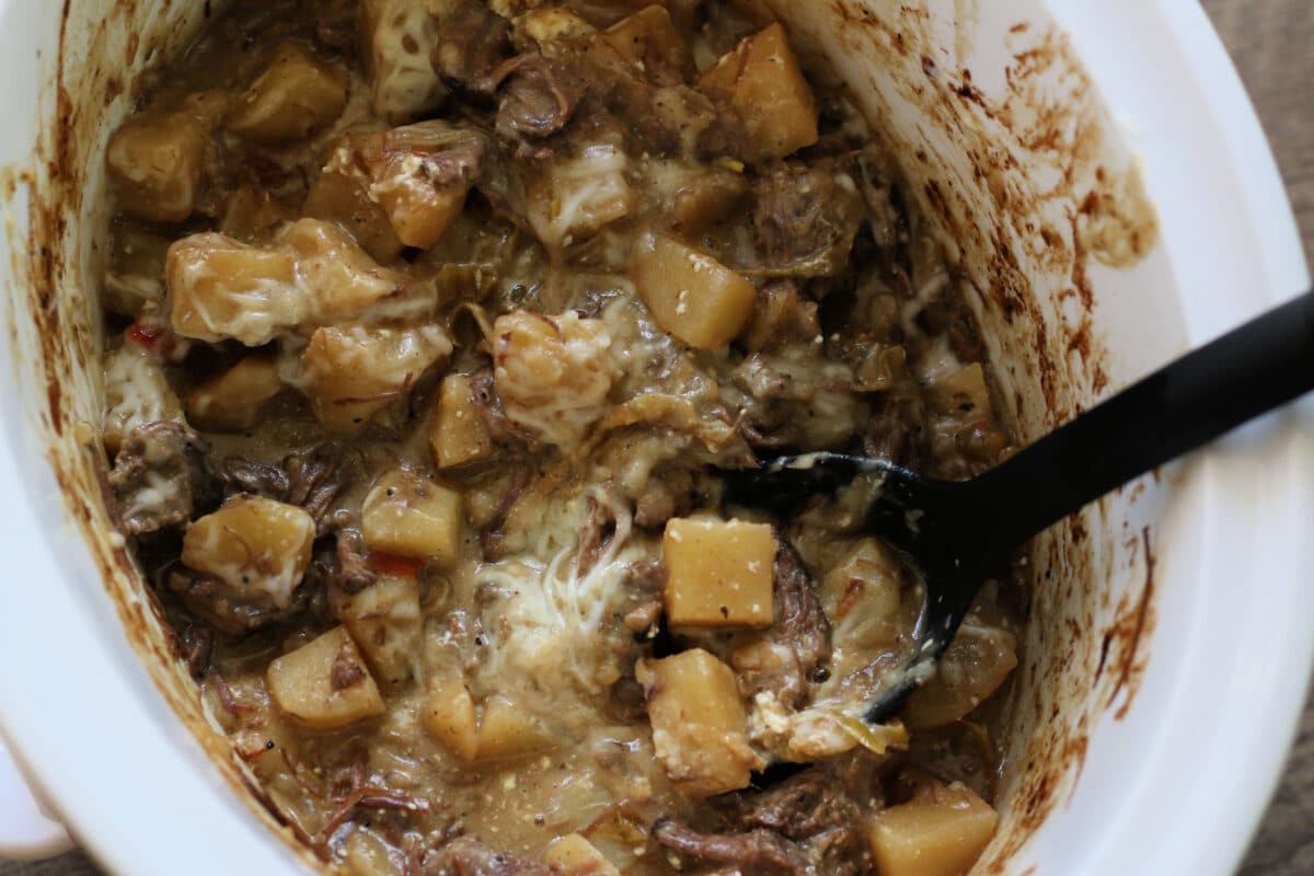 Crock Pot Cheesesteak Potato Casserole--tender potatoes, leftover roast beef, peppers and onions with cream cheese and melty provolone for an easy slow cooker dinner.