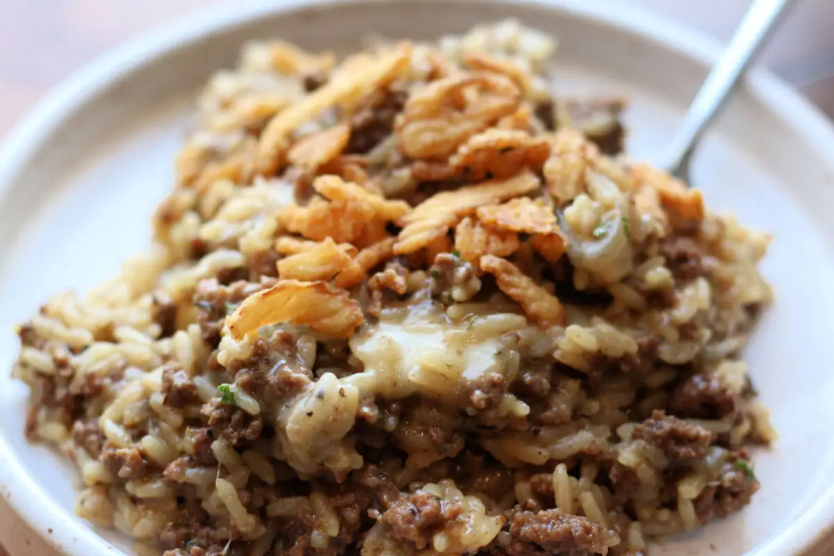 Incredible French Onion Ground Beef Casserole--an easy Instant Pot dinner made with ground beef, sliced onions, seasoned rice, melted Parmesan and mozzarella and crispy French fried onions on top.