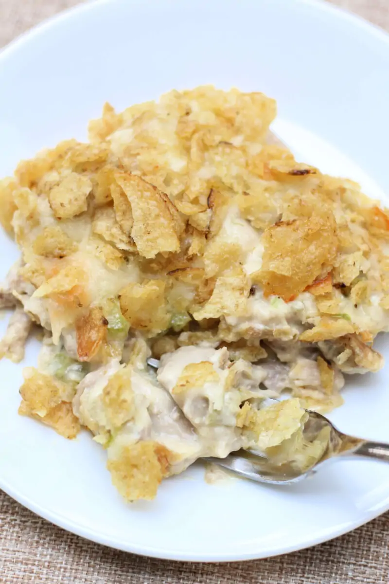 Joy's Memory Making Chicken Casserole--comfort food chicken casserole with tender shredded chicken, creamy sauce, dill pickle flavor, melty Monterey Jack cheese and a buttery potato chip topping.