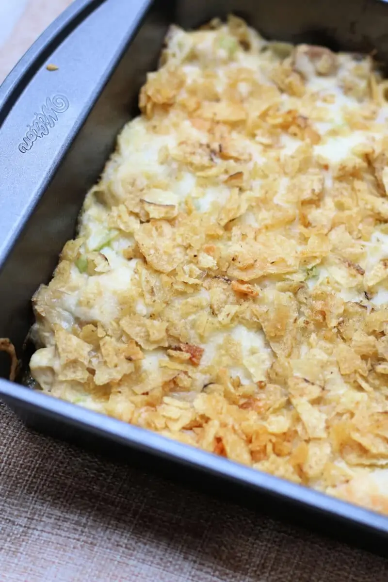 Joy's Memory Making Chicken Casserole--comfort food chicken casserole with tender shredded chicken, creamy sauce, dill pickle flavor, melty Monterey Jack cheese and a buttery potato chip topping.