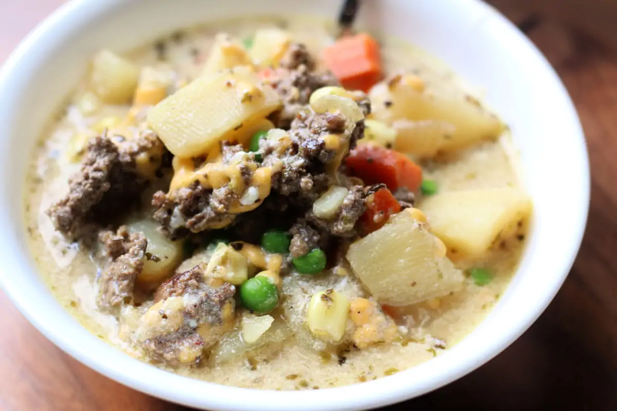 Protein Packed Shepherd's Pie Soup--a creamy, tangy soup with ground beef or lamb, tender potatoes, carrots, peas, corn and then it's finished off with Greek yogurt and cheddar cheese.