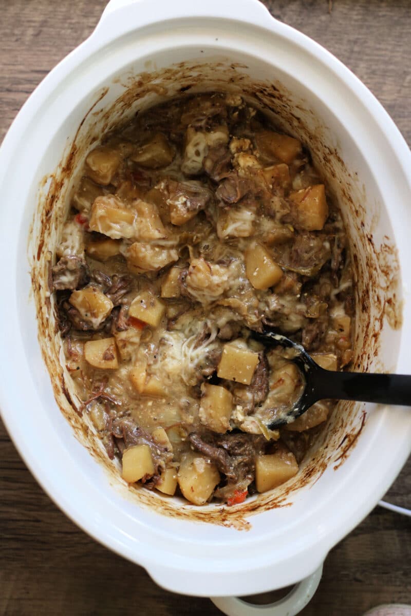 Crock Pot Cheesesteak Potato Casserole--tender potatoes, leftover roast beef, peppers and onions with cream cheese and melty provolone for an easy slow cooker dinner.