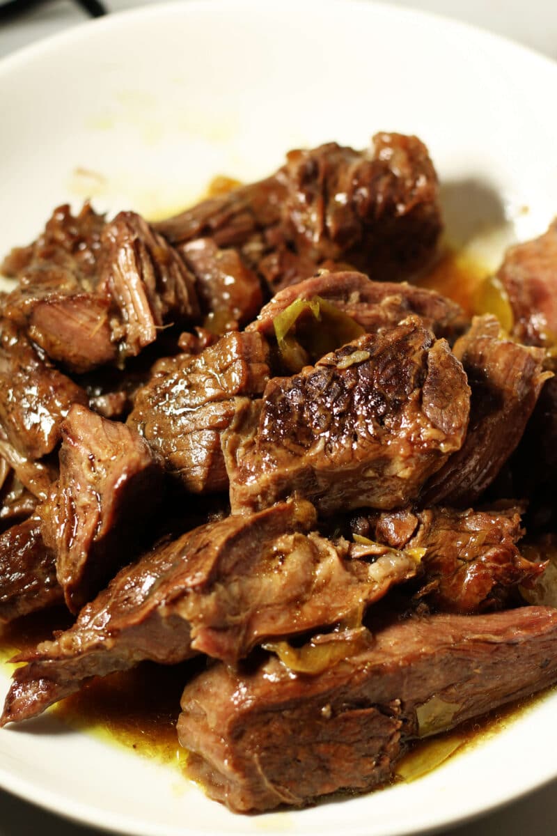 Tender Slow Cooker Mississippi Pot Roast--tender chuck roast, au jus seasoning, pepperoncini peppers and butter for a juicy, flavorful beef dinner with just five ingredients that you can make in the slow cooker or the Instant Pot.