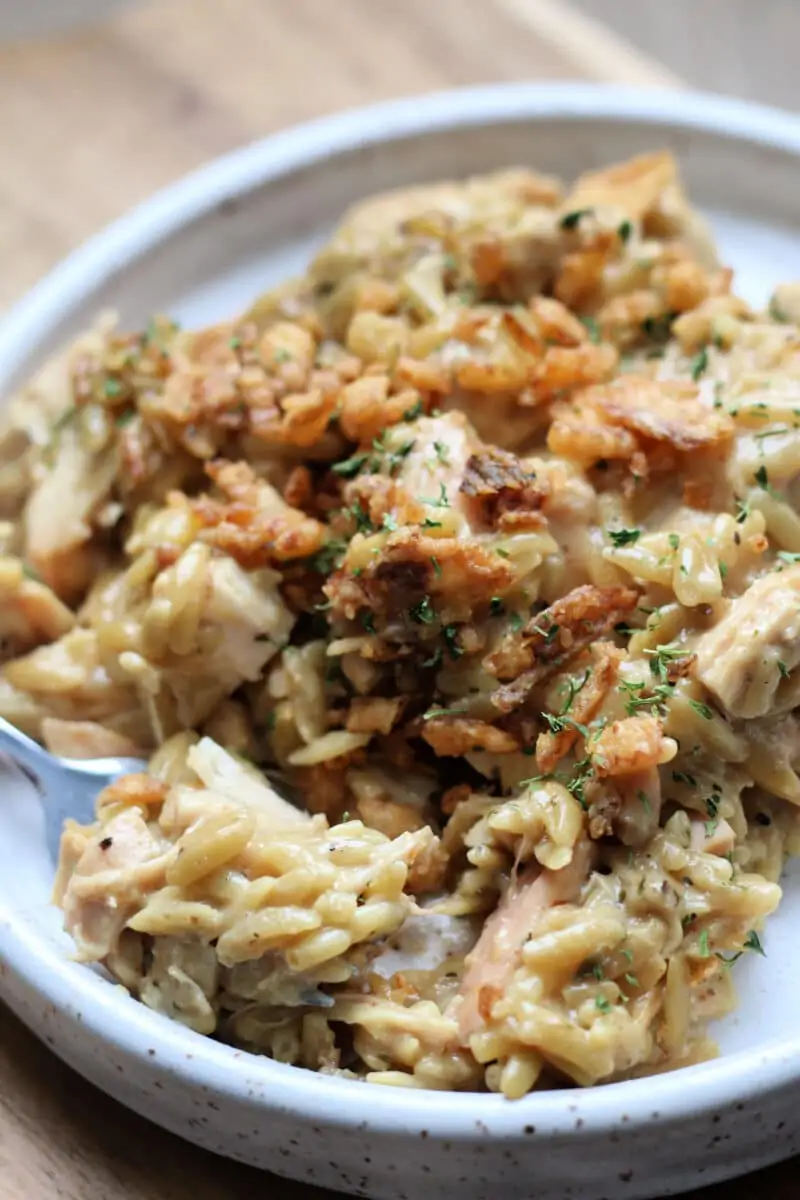 French Onion Chicken Orzo Casserole--an easy Instant Pot dinner with tender chicken and creamy orzo with savory caramelized onions, Parmesan cheese and crispy French fried onions.