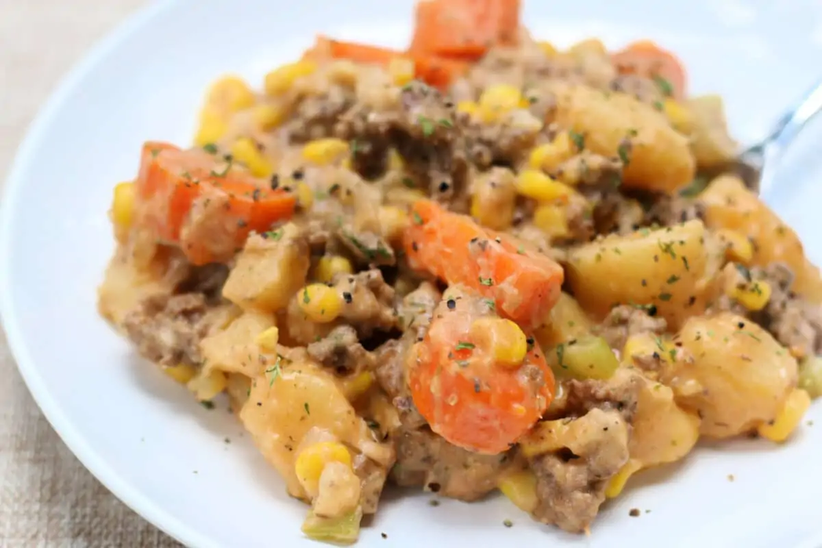 Cozy Farmhouse Beef and Potato Casserole--a cheesy beef and potato casserole that's an easy one-pot dinner made with ground beef, tender potatoes, carrots, corn and cheddar cheese in the Instant Pot or slow cooker.