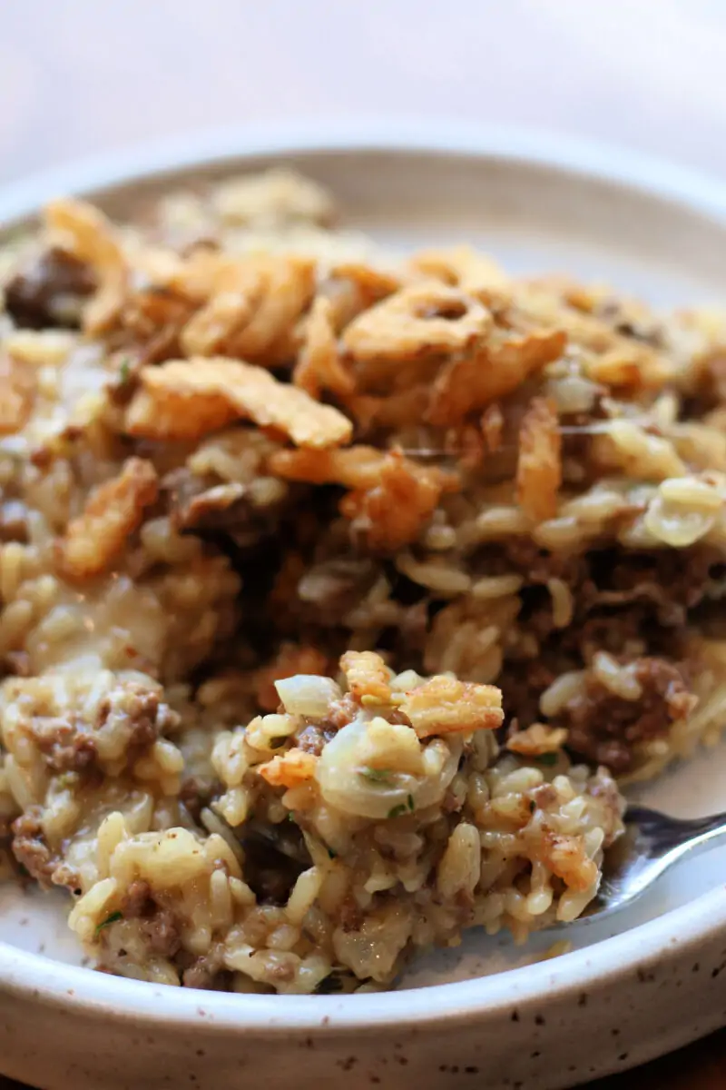 Incredible French Onion Ground Beef Casserole--an easy Instant Pot dinner made with ground beef, sliced onions, seasoned rice, melted Parmesan and mozzarella and crispy French fried onions on top.