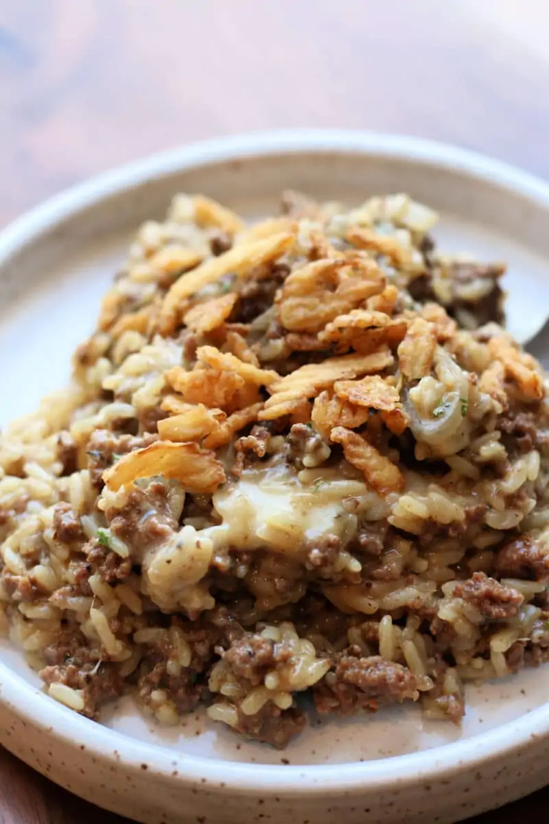 Incredible French Onion Ground Beef Casserole--an easy Instant Pot dinner made with ground beef, sliced onions, seasoned rice, melted Parmesan and mozzarella and crispy French fried onions on top.