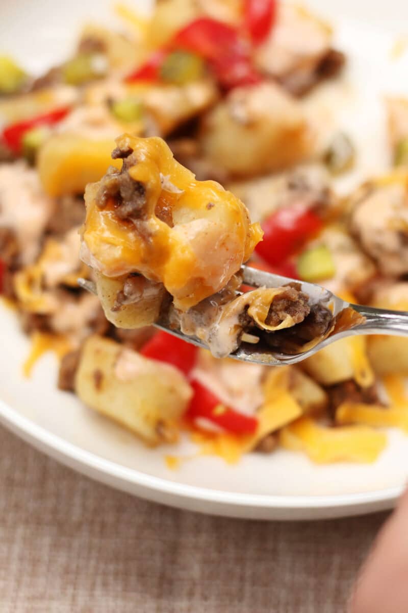 In-N-Out Animal Style Cheeseburger Casserole--an easy Instant Pot dinner with seasoned ground beef, tender potatoes, melted cheddar cheese, pickles, tomatoes and a creamy homemade burger sauce.