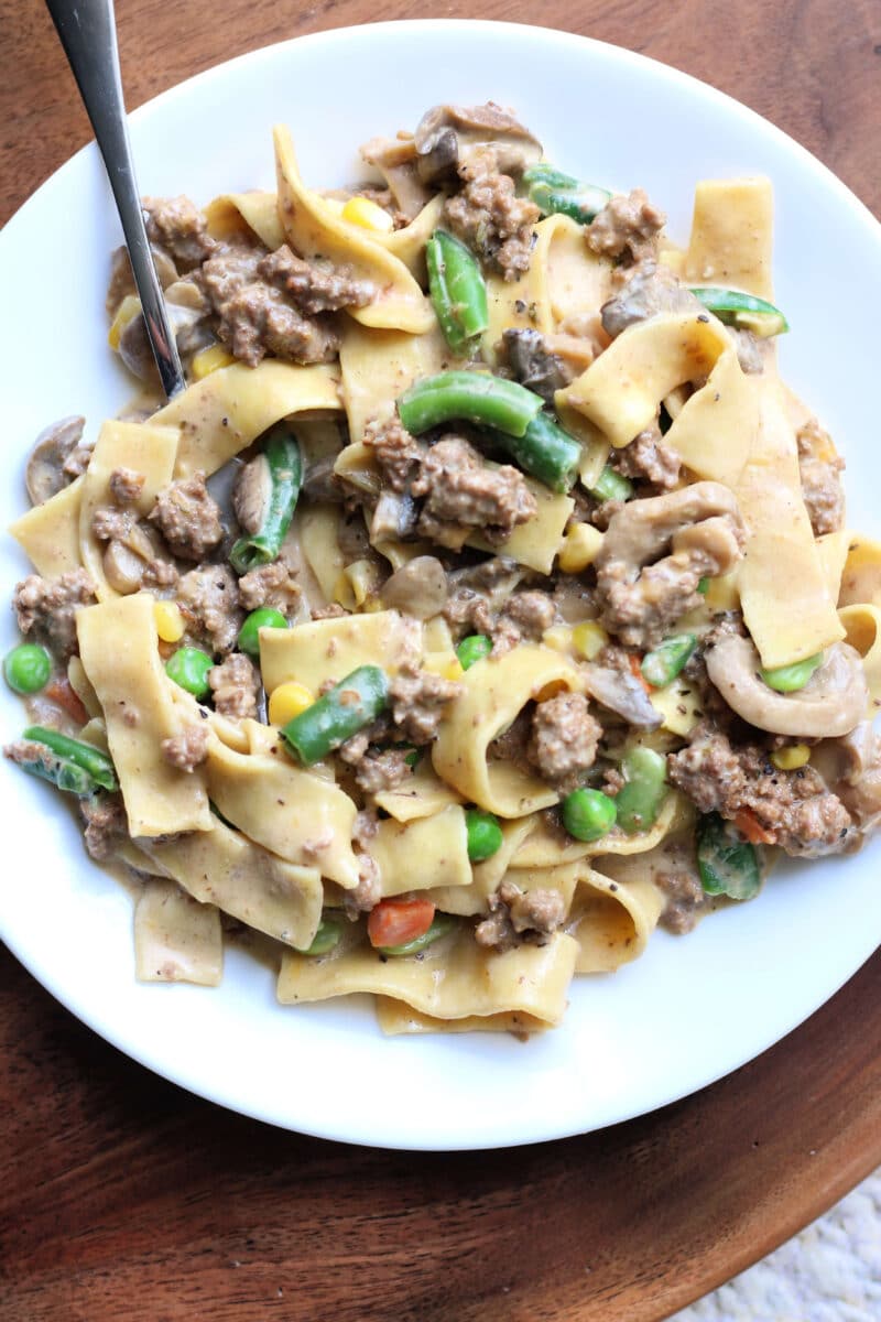 Dolly Parton's Creamy Beef Noodle Casserole--an easy one-pot dinner made with seasoned ground beef, tender egg noodles, vegetables, mushrooms, sour cream and cheddar cheese.