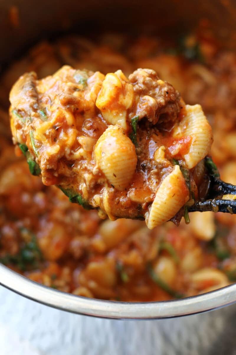 Amish Frolic Casserole--an easy Instant Pot pasta dinner made with ground beef, medium pasta shells, tomato basil sauce, fresh spinach, mushrooms and melty cheddar cheese.