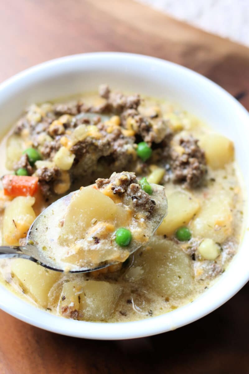 Protein Packed Shepherd's Pie Soup--a creamy, tangy soup with ground beef or lamb, tender potatoes, carrots, peas, corn and then it's finished off with Greek yogurt and cheddar cheese.