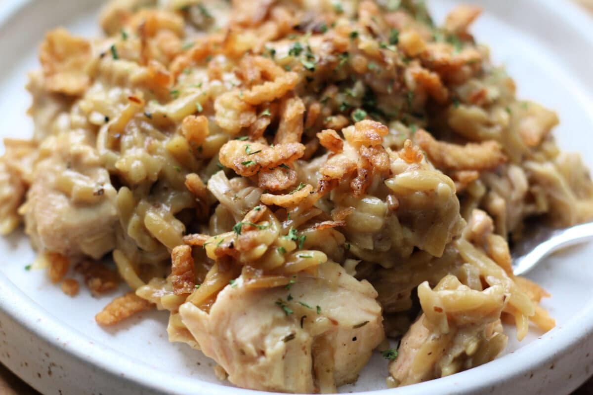 French Onion Chicken Orzo Casserole--an easy Instant Pot dinner with tender chicken and creamy orzo with savory caramelized onions, Parmesan cheese and crispy French fried onions.