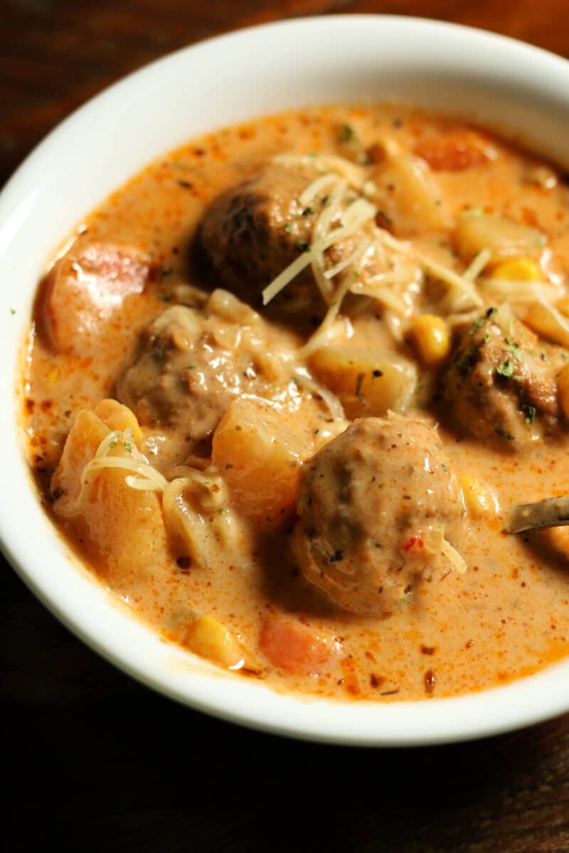 Crockpot Cheesy Italian Meatball Soup--an easy dump and go slow cooker soup made with tender meatballs, potatoes, vegetables and Parmesan cheese in a creamy, savory broth.