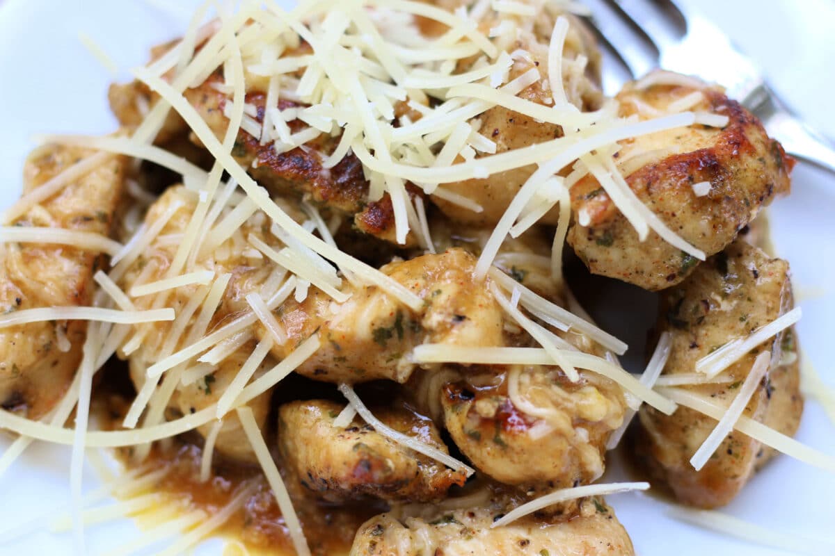 Simple Garlic Parmesan Butter Chicken--tender, juicy pieces of seasoned chicken cooked in a skillet and finished with a buttery garlic Parmesan sauce for a quick and easy dinner.