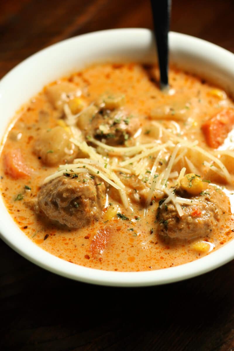Crockpot Cheesy Italian Meatball Soup--an easy dump and go slow cooker soup made with tender meatballs, potatoes, vegetables and Parmesan cheese in a creamy, savory broth.